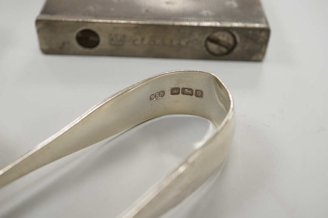 A collection of small silver to include a cigarette case, two napkin rings, three pairs of sugar tongs, a thimble, a lady's wrist watch and a mounted glass toilet jar. together with a 925 fob watch, a 935 mounted lighter